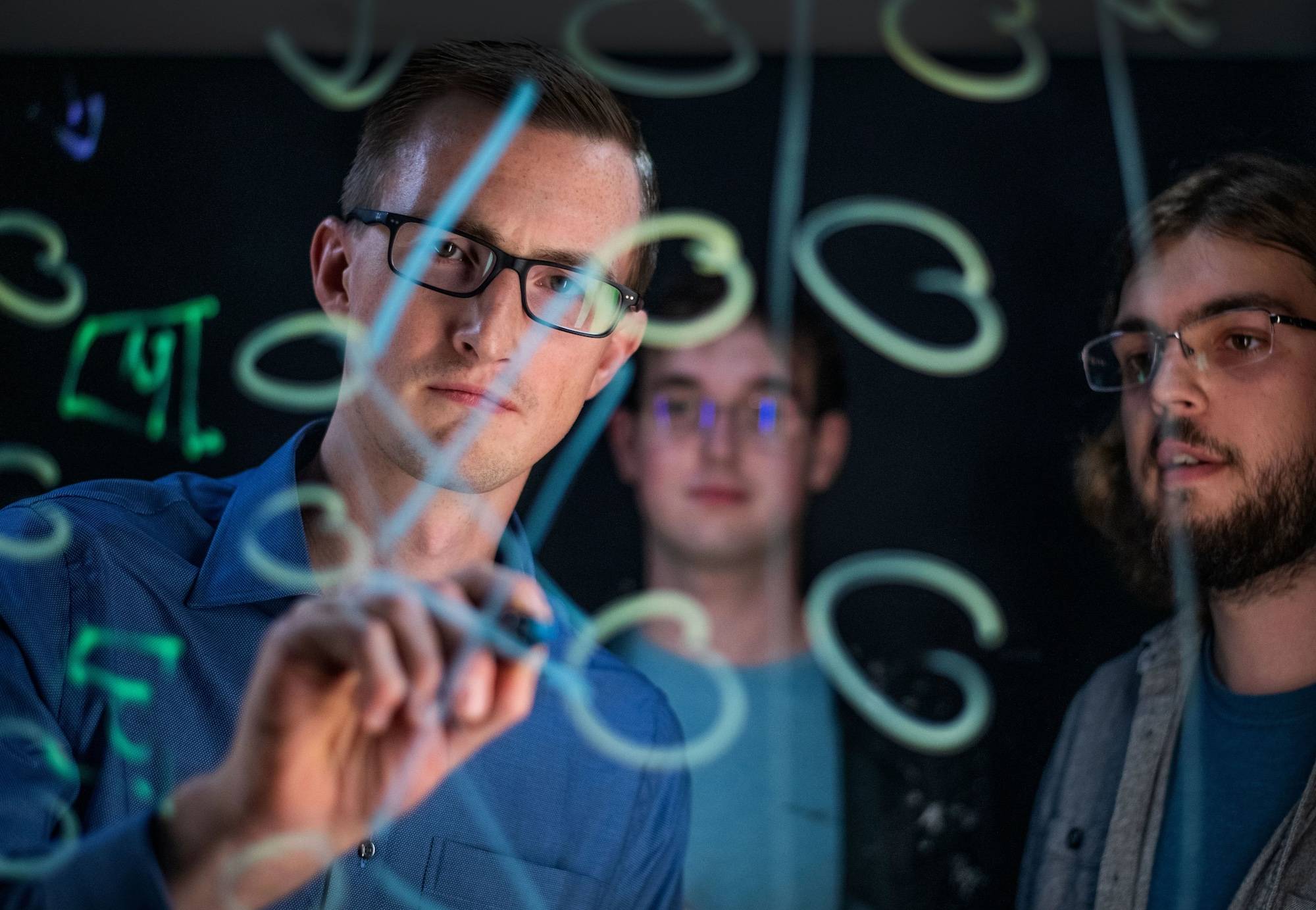 Developers collaborating on a whiteboard